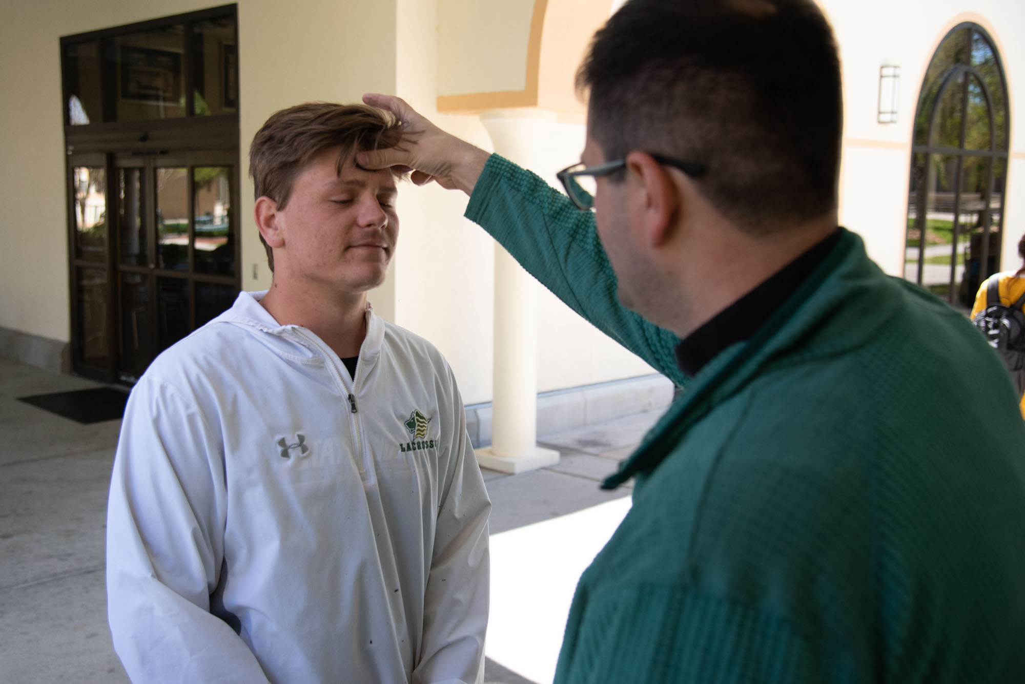 Jordan Williams, sophomore, receives ashes from Father Kyle Smith_edited